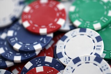 Close up of a group of casino chips on a green mat for poker or dice games indoors