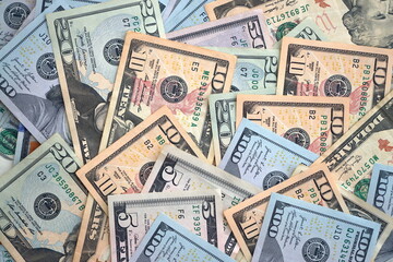 Big amount of different dollar bills close up. Hundred fifty twenty ten and five dollar banknotes