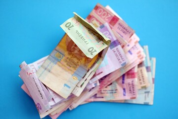 Ukrainian money bills on light blue paper background