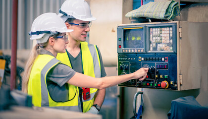 Engineers team mechanic using computer controller Robotic arm for welding steel in steel factory workshop. Industry robot programming software for automated manufacturing technology