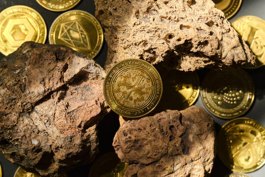 Xrp Token Placed on Rocks With Coins Scattered Around