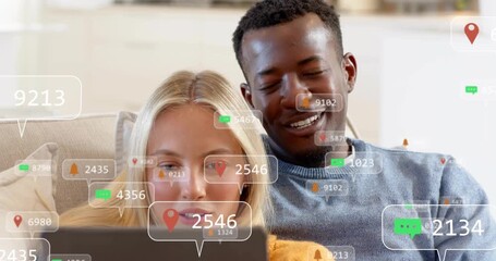 couple opening tablet and notifications appearing around faces measuring social media engagement - Powered by Adobe
