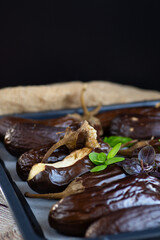 natural baked eggplants close-up on a dark background