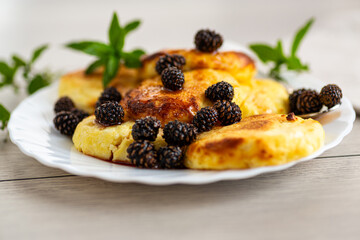 Traditional cottage cheese pancakes topped with pine cone syrup