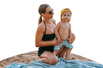 Healthy caucasian boy spending time with mom sits on plaid  against transparent background. Pretty woman in black swimsuit hugging son at seashore wears sunglasses