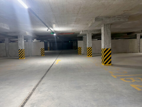 View of empty underground parking with dedicated spots - Powered by Adobe