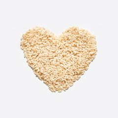 Heart shape made of rice grains on white background symbolizing love and nutrition.