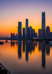 Naklejka premium Tianjin skyline reflecting in hai river during golden hour sunset