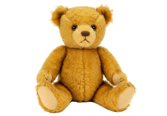 Isolated golden-brown teddy bear with tan paws sitting up on a soft surface, cute stuffed toy