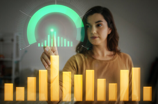 Businesswoman interacting with holographic bar chart and performance dial