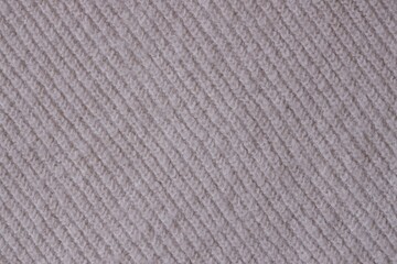 Texture of knitted pastel pink sweater, close-up texture of beige pink