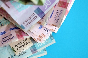 Ukrainian money bills on light blue paper background