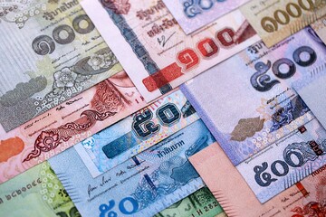 Thai Baht currency money bills. THB currency banknotes in pile with different denomination close up