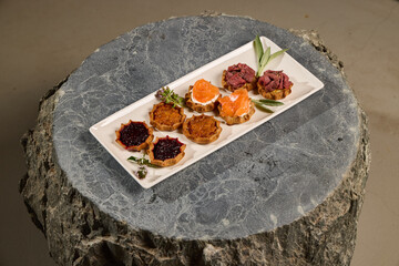 Beautifully Artfully Arranged Gourmet Tartlets Displayed on an Elegant Serving Board