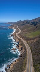 A scenic road hugs the coastline, showcasing cliffs on one side and gentle waves lapping at the shore under a sunny sky