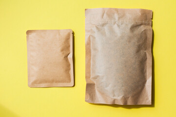 Blank craft plastic pouch, white pack on studio background with shadow, mylar bag isolated for coffee or food, cosmetic products, snack, candy. Different sizes, mock up.