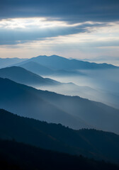 Fototapeta premium Blue Mountain Range Under a Misty Sky