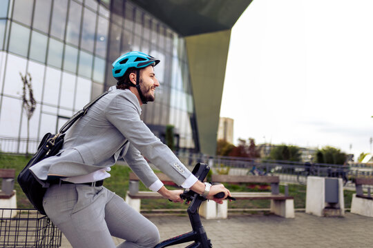 Young businessman riding an electric bike to work, wearing a professional suit. Modern urban commute, combining business style with eco-friendly transportation.