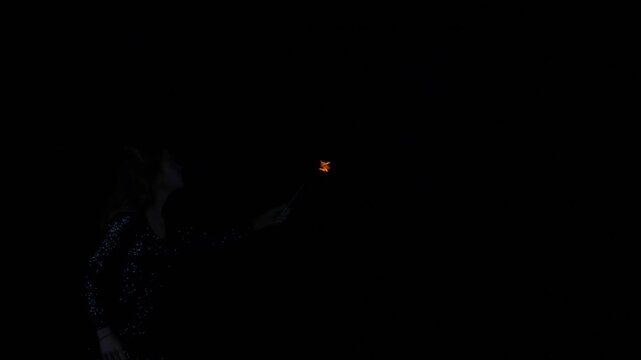 Woman fire breather blowing a fireball in slow motion.