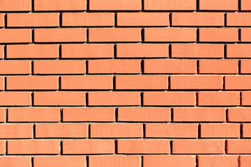 Close up of red brick wall texture. Horizontal rows of masonry construction background. Building material structure for architecture and industrial design concept with orange tone.