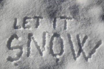 Let it snow sign in the snow
