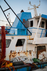 Rusty Fishing Boat with Broken Windows and Fishing Nets