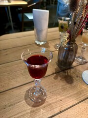 Elegant Glass of Red Liqueur on Wooden Table