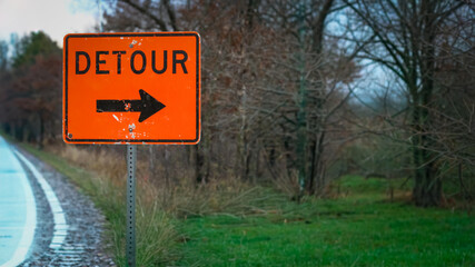 DETOUR sign with a arrow in winter with copy space. Construction, transportation and infrastructure background. Project communication. Business or life metaphor abstract design element.