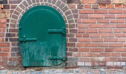 old brick wall with green door