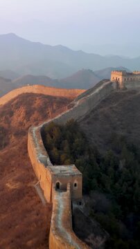 Flying over the Great Wall of China at sunrise. Vertical Video,