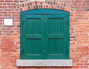 old green wooden door on red brick building at distillery district