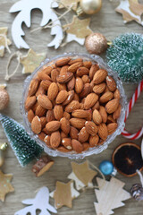 Various Christmas decorations, cookies, chocolate and nuts on wooden background. Flat lay.