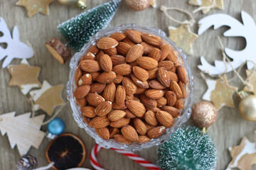 Various Christmas decorations, cookies, chocolate and nuts on wooden background. Flat lay.