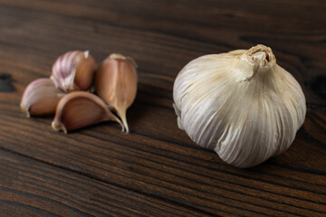 Fresh Garlic Cloves and Whole Bulb on Rustic Wooden Surface