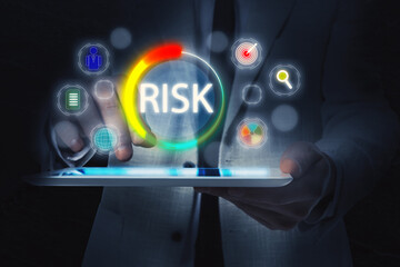 Man using tablet computer in darkness, closeup. Different icons and scale of risk level above device