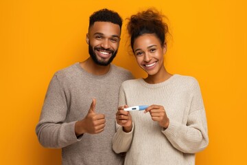 Happy African American couple showing a positive pregnancy test