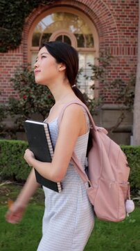 Asian female college student walking to her class. Vertical Video.