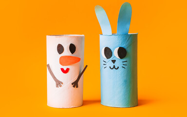 Christmas toy from toilet tube roll, paper toy santa claus, snowman, reindeer, tree rabbit on yellow background. Holiday easy kids DIY, decoration idea for winter season, home party. Children's crafts