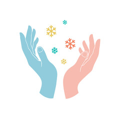 Fototapeta premium Hands catching colorful snowflakes in winter concept 