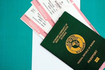 Nigerian passport and boarding pass tickets on flag close up. The concept of travel and vacation