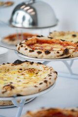Assortment of Freshly Baked Pizzas at a Buffet
