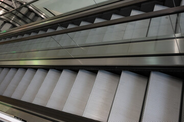 Obraz premium Modern Escalators and Elevators in a Contemporary Building Interior