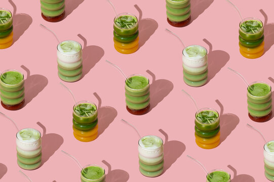 Creative colorful pattern composition made with various matcha drinks on pastel pink background. Minimal healthy matcha tea concept. Trendy drink idea.