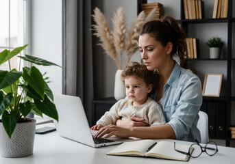 Remote work and motherhood, a focused young mother works on her laptop,symbolizing the challenge of balancing career and family