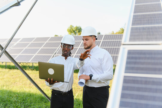 Engineers discussing solar energy project data