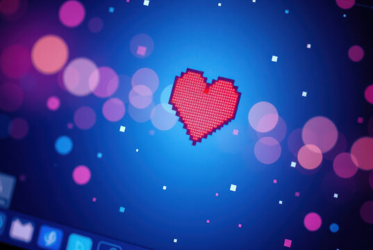 Close-up of a pixel cursor on a heart – digital affection.