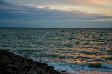Moody Twilight Seascape with Ocean Waves Crashing on Dark Coastal Rocks