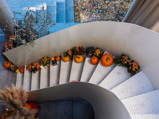 Poznan Poland - 19.10.2025: Staircase decorated with pumpkins flowers and candles for autumn...