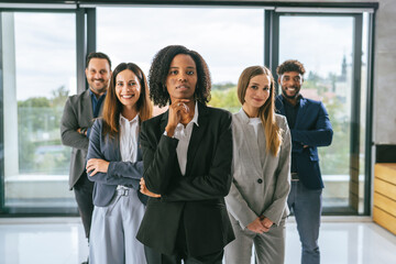 Obraz premium Diverse business team standing in office achieving success