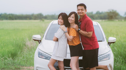Happy family traveling on holiday by car. Parents and daughter spend free time together